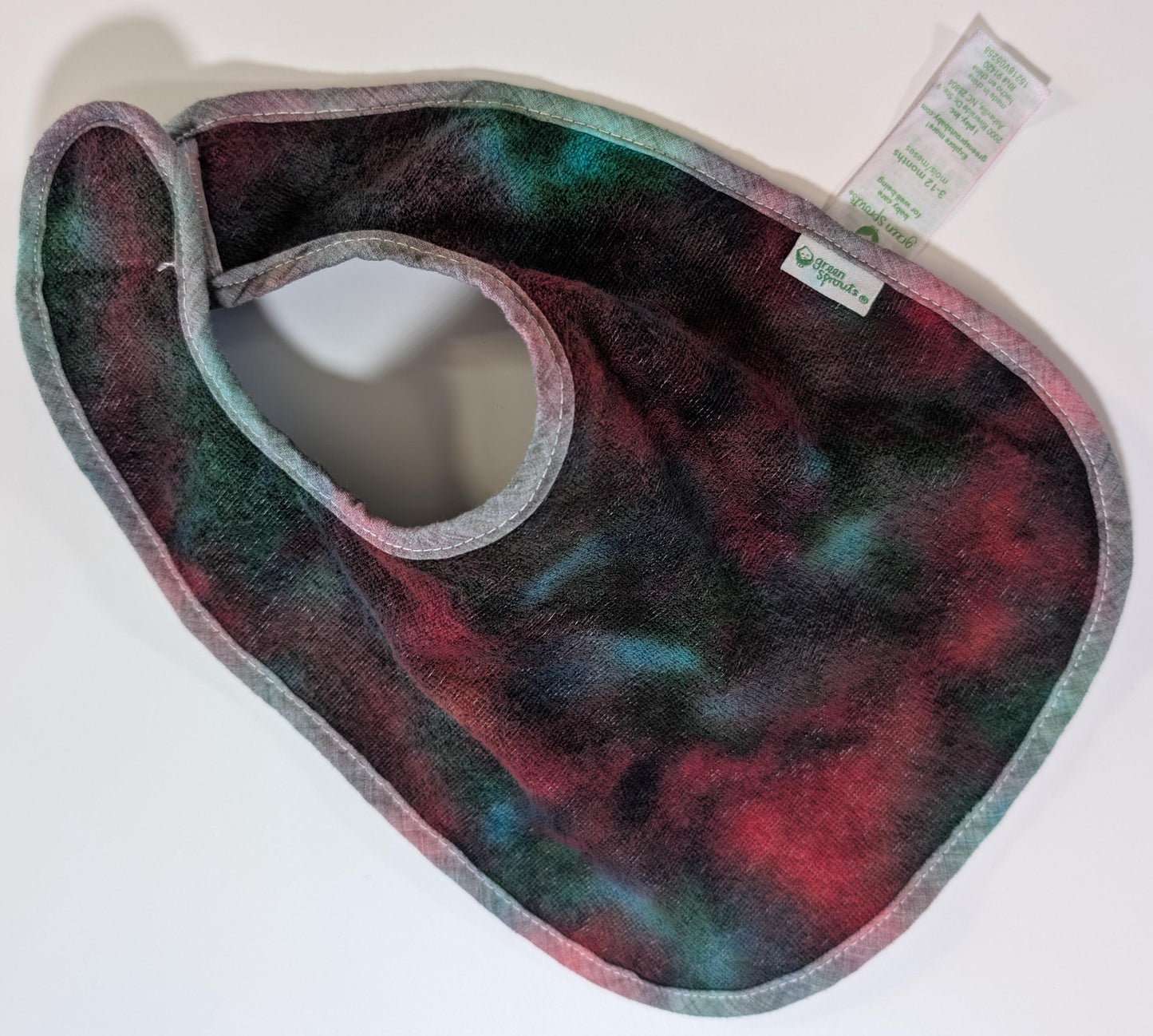3-12 Scrunch in Greens, Reds & Black Tie Dye on a Green Sprouts Baby Bib