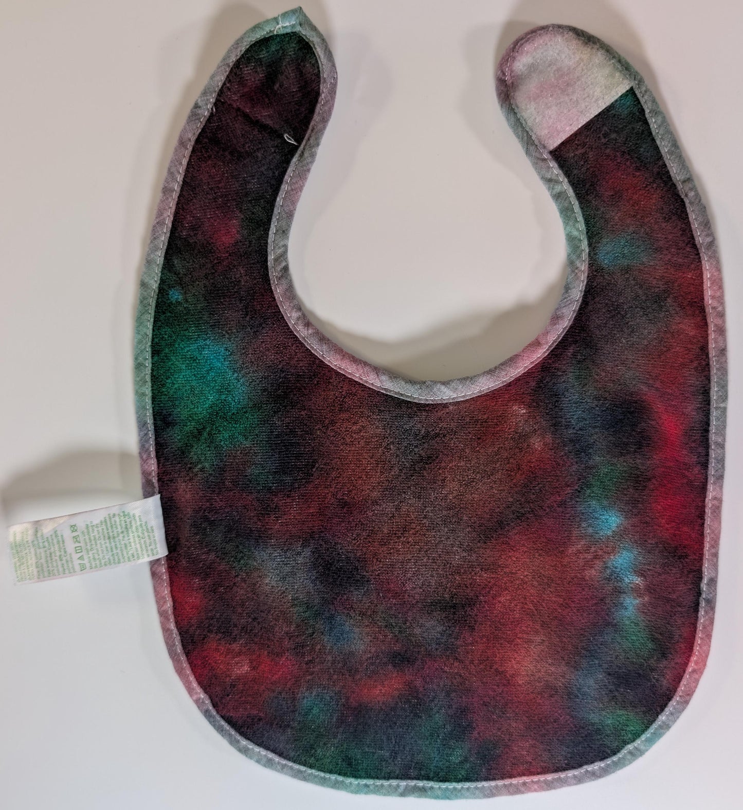 3-12 Scrunch in Greens, Reds & Black Tie Dye on a Green Sprouts Baby Bib