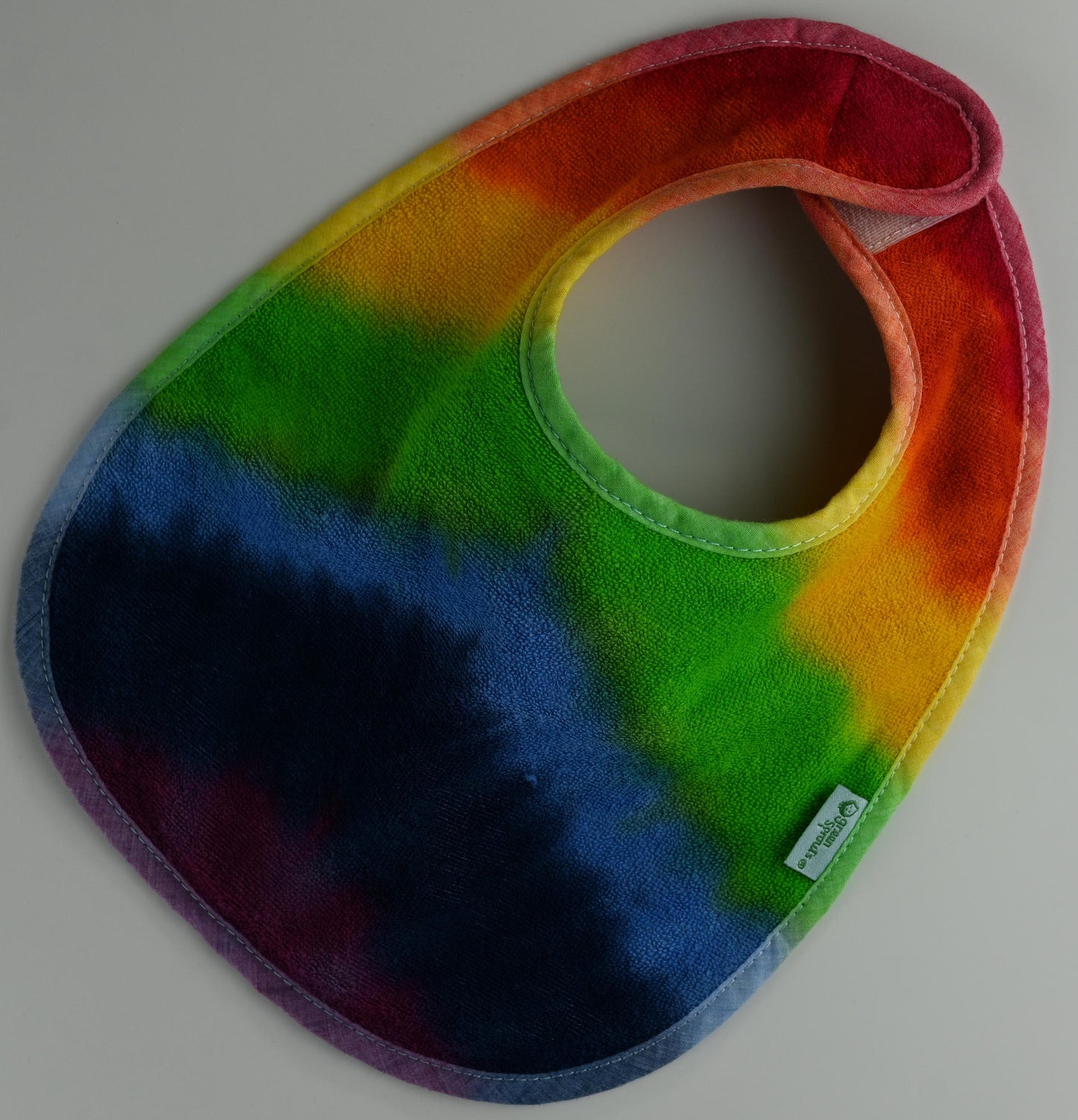 3-12 Months Rainbow Tie Dye on a Green Sprouts Baby Bib