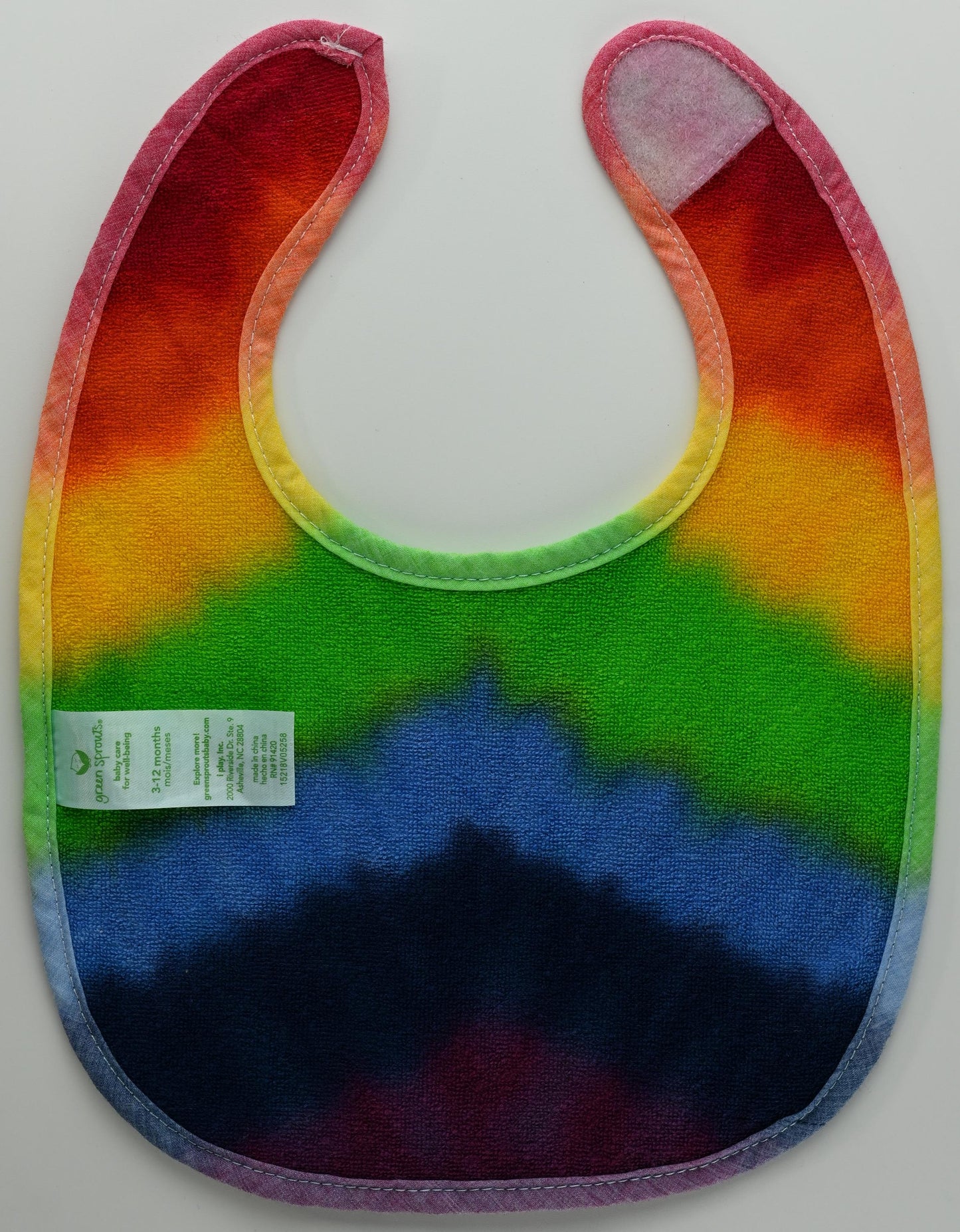 3-12 Months Rainbow Tie Dye on a Green Sprouts Baby Bib