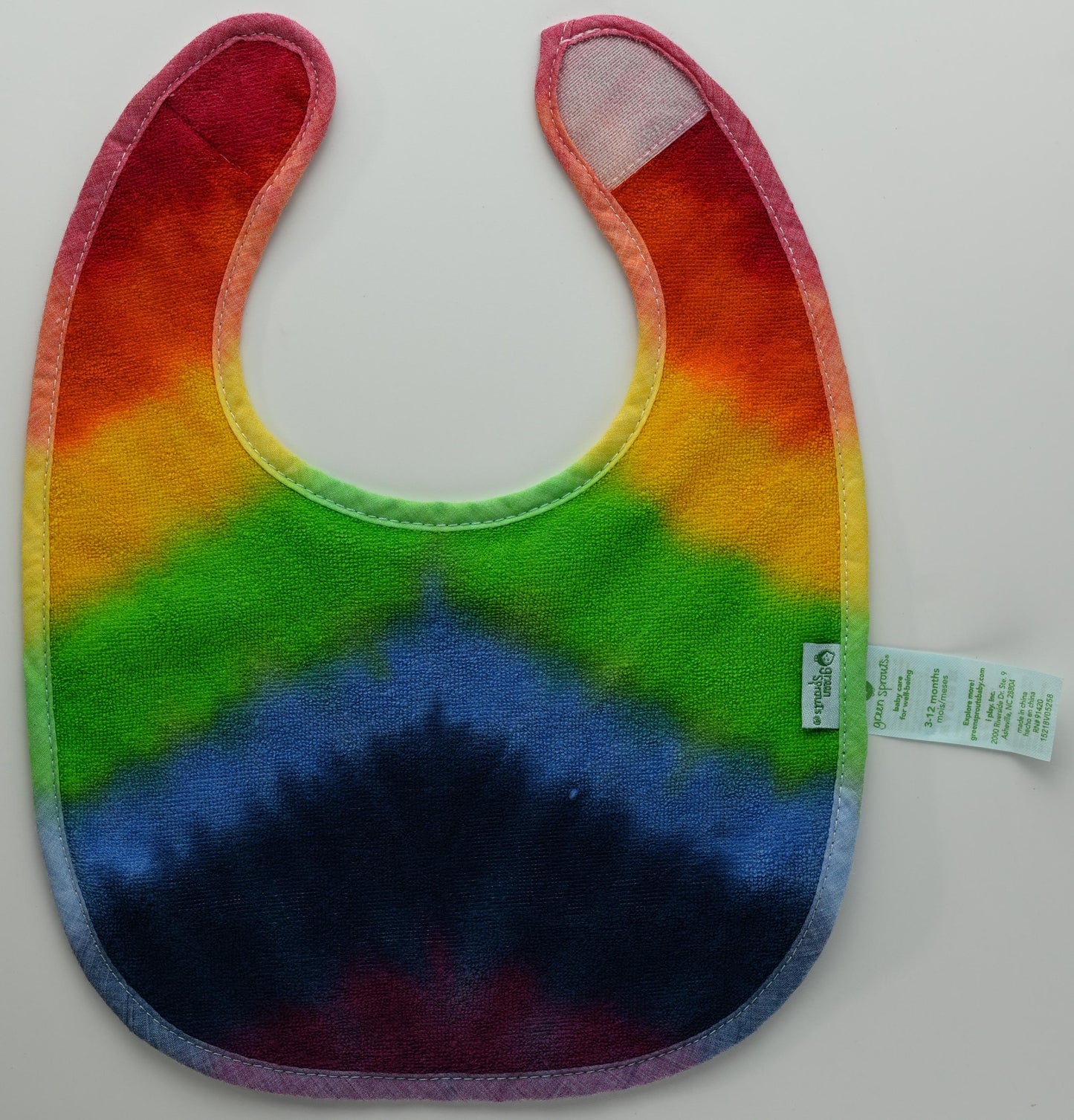 3-12 Months Rainbow Tie Dye on a Green Sprouts Baby Bib