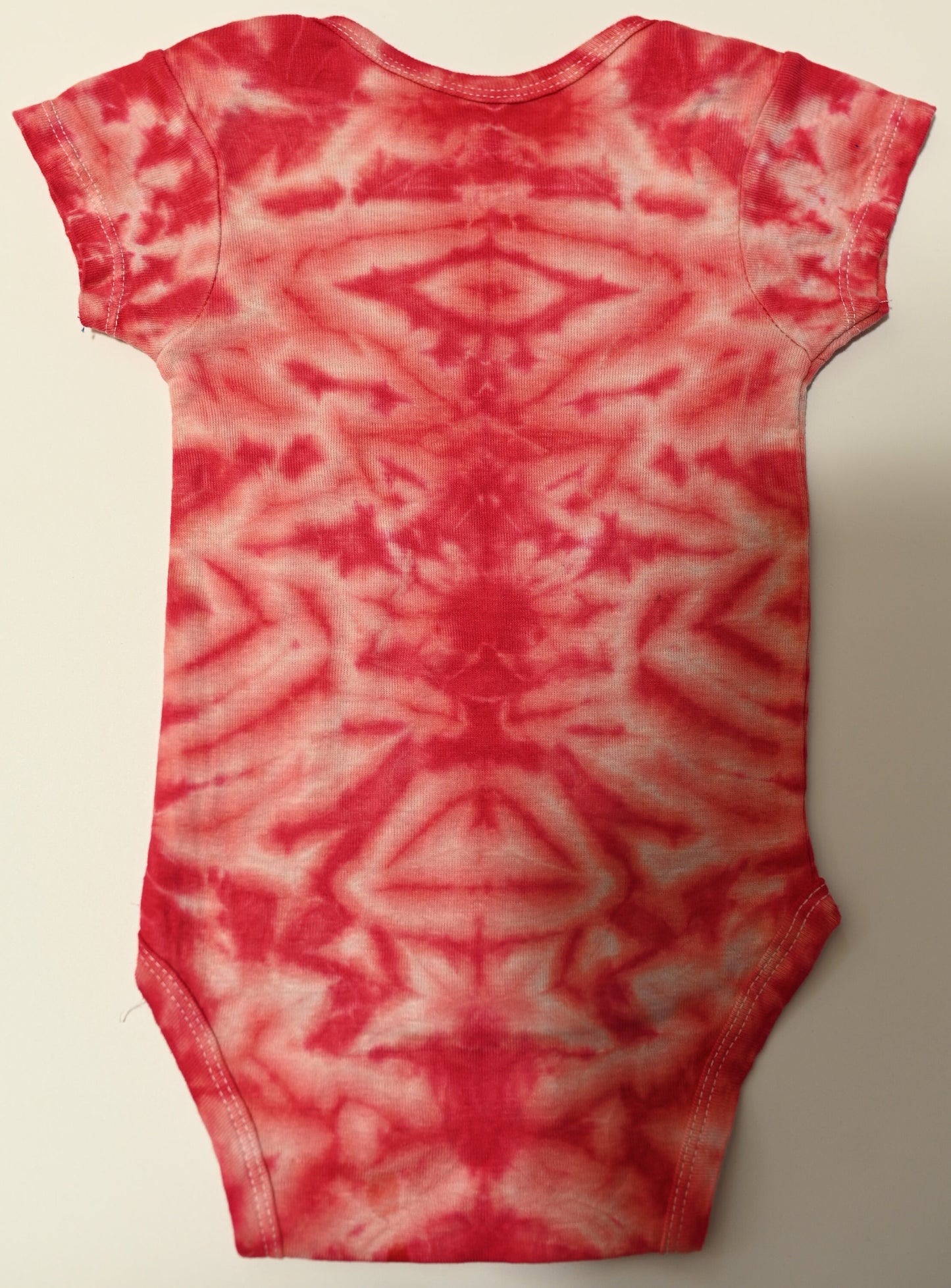 12 Month Scrunch in Pink and Red Tie Dye on a Gerber Cotton Onesie